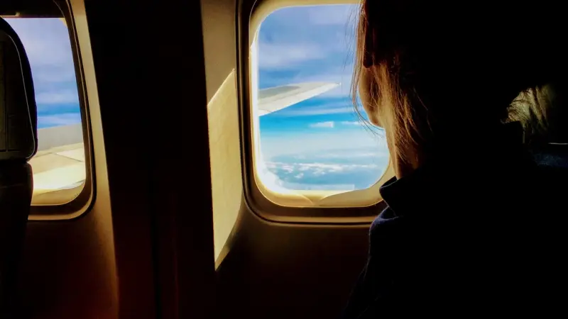 A traveller looking out of an aeroplane window