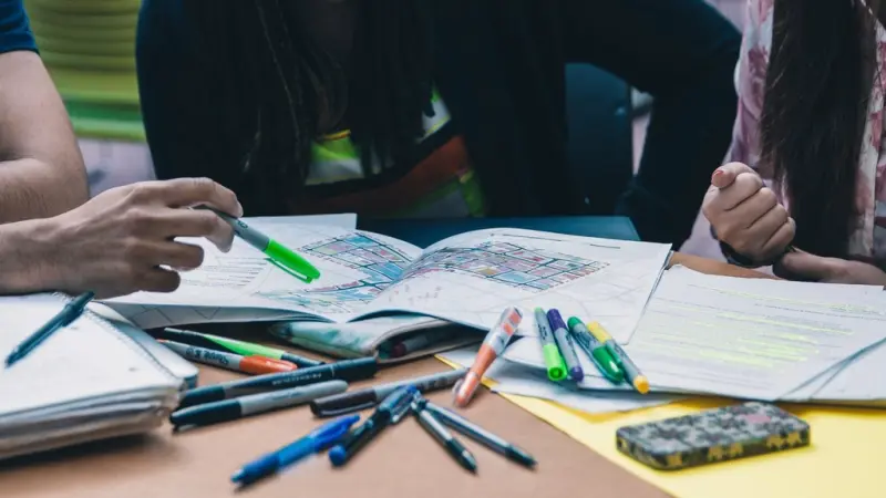 Students studying together with notes and highlighters